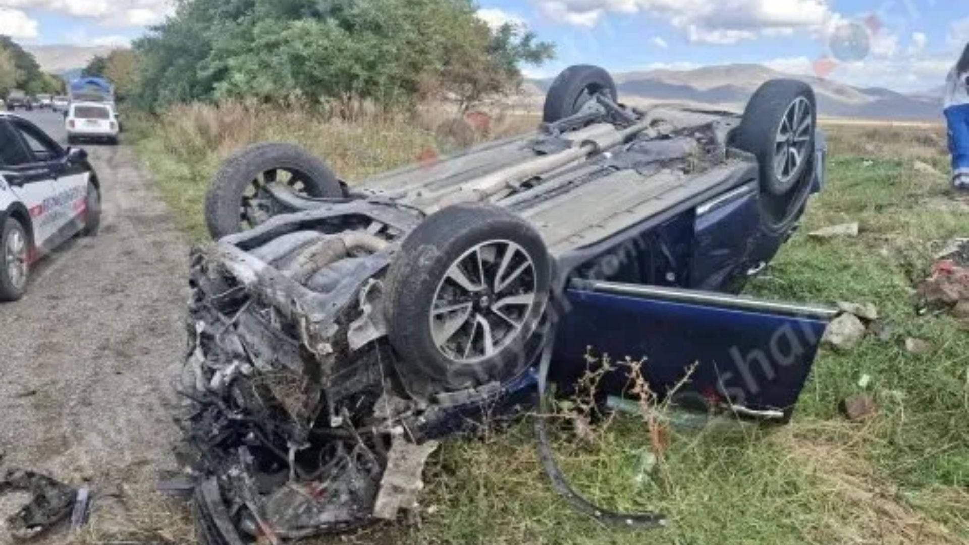 The car hit a dirt embankment and overturned. The driver was unconscious.